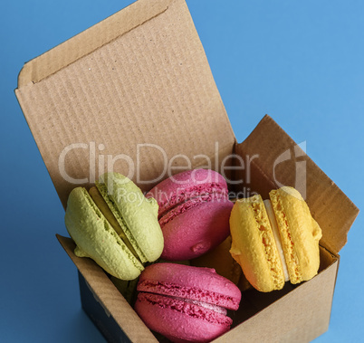 multicolored cakes of almond flour in a brown paper box