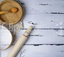 wooden round plates, sieve and rolling pin
