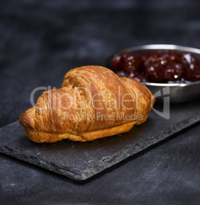 baked croissant on a black graphite background