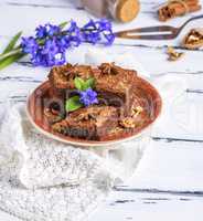 chocolate brownie pieces lie on a round plate