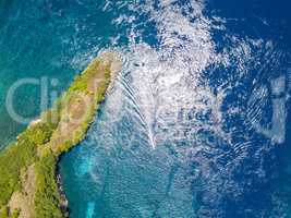 Island in the Ocean and a Boat Trimaran. Aerial View