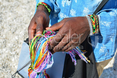 Colorful string in black man's hands