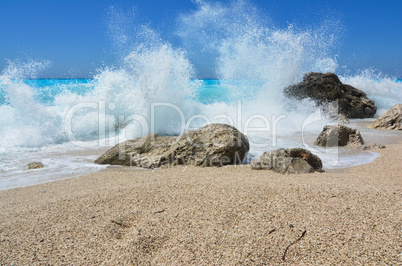 Big wave splashing over stones