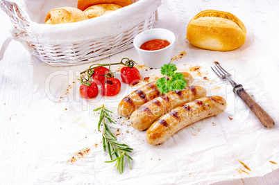 delicious bratwurst with ketchup and fresh rolls