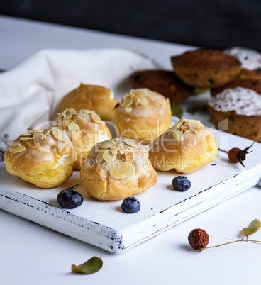 baked profiteroles with custard sprinkled with almonds