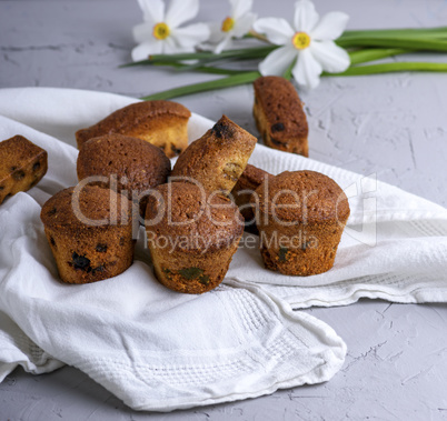 small round baked muffins with dry fruits and raisins on a white