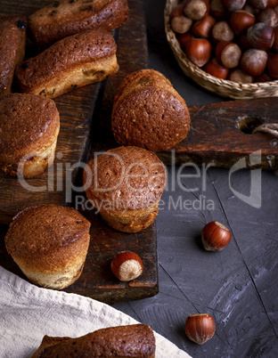 baked small cupcakes on a brown wooden board