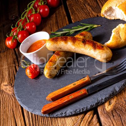 rustic bratwurst with ketchup and fresh rolls