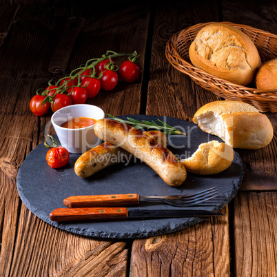 rustic bratwurst with ketchup and fresh rolls