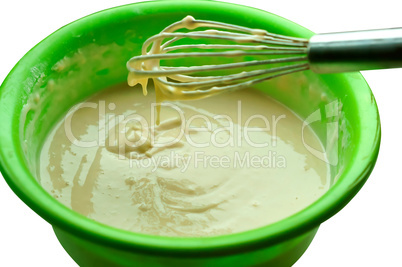 dough in a bowl and whisk for mixing, liquid dough for pancakes, ready dough for baking pancakes
