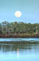 Moonrise over River leading to the ocean at Clam Pass