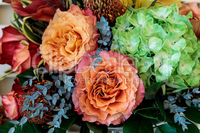 Bouquet of flowers including roses, orchids, pincushion proteas