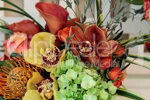 Bouquet of flowers including roses, orchids, pincushion proteas