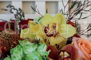 Bouquet of flowers including roses, orchids, pincushion proteas