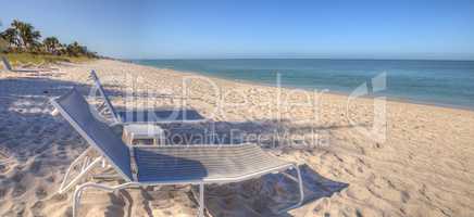 Two beach chairs under a Clear blue sky over Lowdermilk Beach