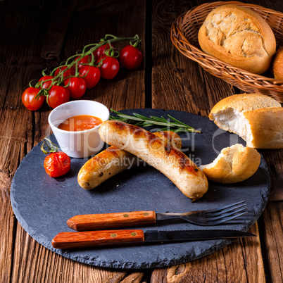 rustic bratwurst with ketchup and fresh rolls