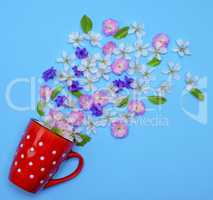 of red ceramic mug with white polka dots randomly poured flower