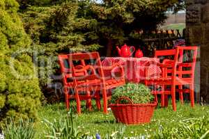 Red tablecloth is in the garden
