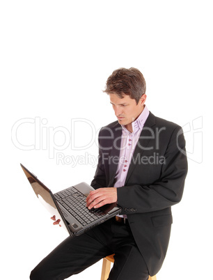 Business man sitting and working on his laptop