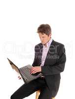 Business man sitting and working on his laptop
