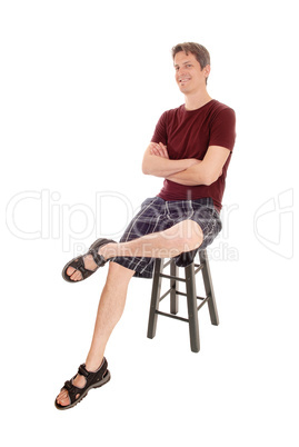 Happy man sitting on a chair smiling