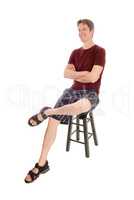 Happy man sitting on a chair smiling