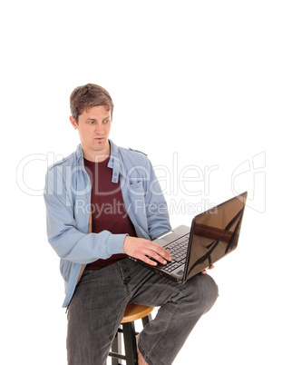 Suspicion man looking at the screen of his laptop