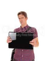 Puzzled man holding up his laptop to see