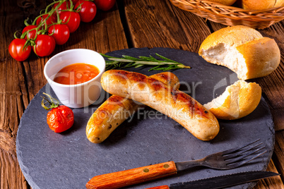 rustic bratwurst with ketchup and fresh rolls