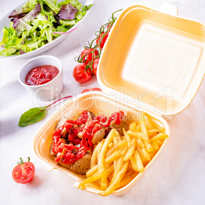 grilled bratwurst with French fries and ketchup