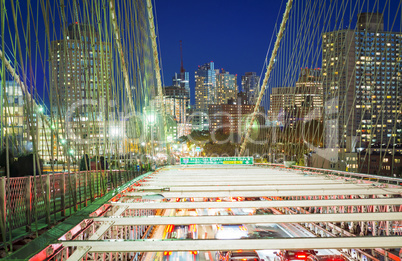 Brooklyn Bridge with car traffic at night