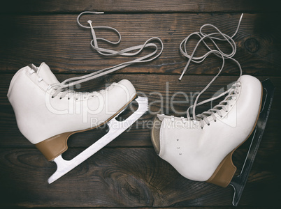 old white female skates for figure skating with unbound laces