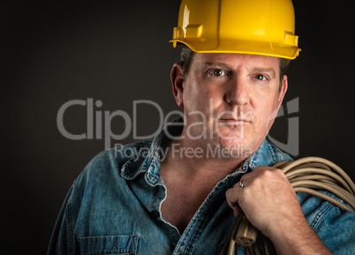 Serious Contractor in Hard Hat Holding Extention Cord With Drama