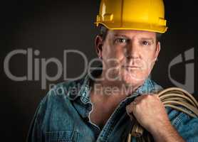 Serious Contractor in Hard Hat Holding Extention Cord With Drama