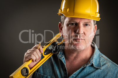 Serious Contractor in Hard Hat Holding Level and Pencil With Dra