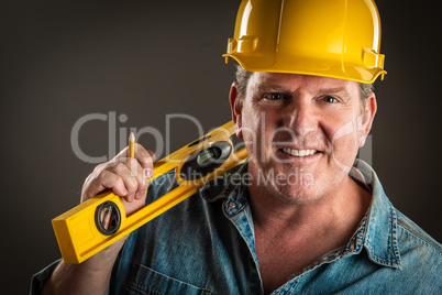 Smiling Contractor in Hard Hat Holding Level and Pencil With Dra