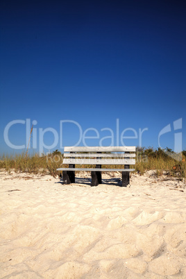 Wood bench on the white sand beach of Delnor-Wiggins Pass State
