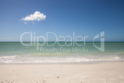 Lone cloud in a Blue sky over white sand of Tigertail Beach