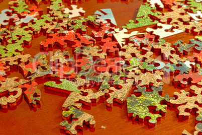 Puzzle pieces spread across a dark wood table
