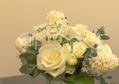 White wedding bouquet of flowers including roses
