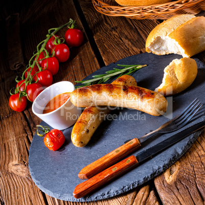 rustic bratwurst with ketchup and fresh rolls