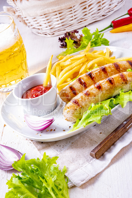 grilled bratwurst with chips and cold beer