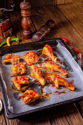 Rustic backed chicken wings,legs on baking tray