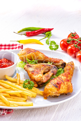 Grilled chicken wings,legs,chips and vegetables