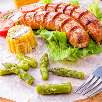 grilled krakauer sausage with boiled corn and green salad