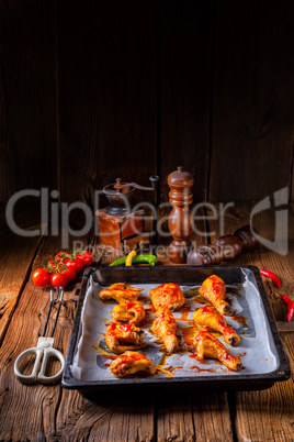 Rustic backed chicken wings,legs on baking tray