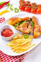 Grilled chicken wings,legs,chips and vegetables