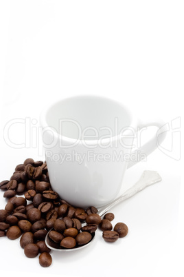 Coffe beans with a cup and spoon