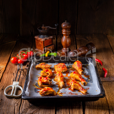 Rustic backed chicken wings,legs on baking tray