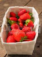 Fresh organic strawberries in a white basket